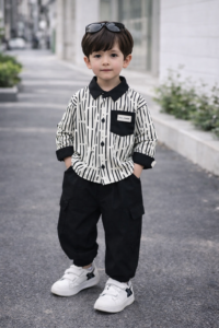 Boys black and white two‑piece outfit with long‑sleeve shirt and solid black pants, displayed for catalog