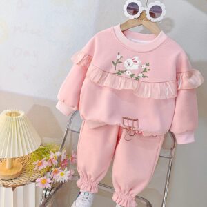 Elegant baby girl outfit set with long‑sleeved ruffled top and matching pants decorated with floral embroidery, displayed flat for catalog.