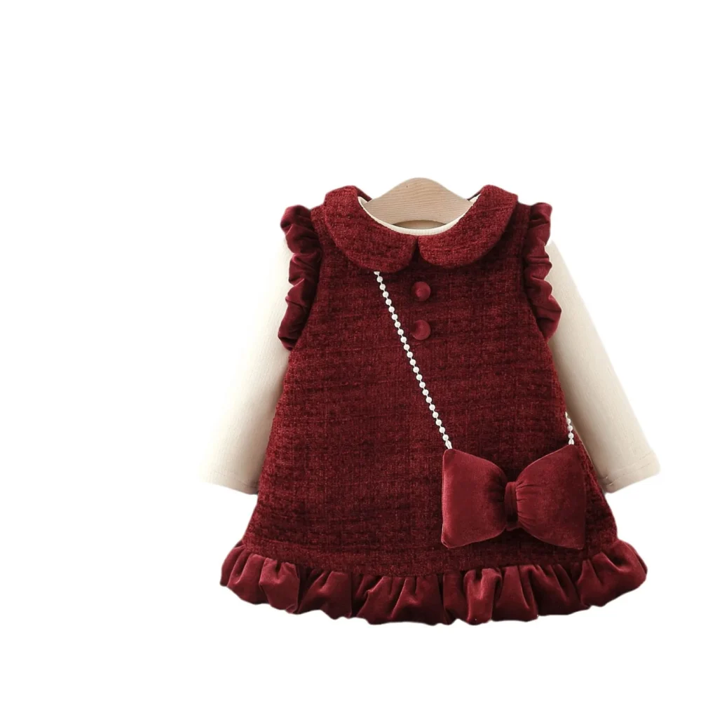 Baby girl red velvet dress set with Peter Pan collar, ruffled trim, decorative buttons, and cream long‑sleeve top, displayed for catalog.