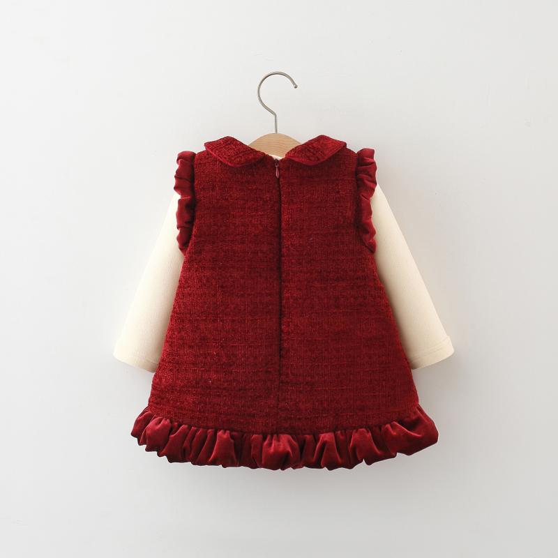 Baby girl red velvet dress set with Peter Pan collar, ruffled trim, decorative buttons, and cream long‑sleeve top, displayed for catalog.