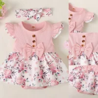 Baby girl floral dress set with ribbed bodice, waist bow, floral skirt, and matching headband, displayed for catalog.