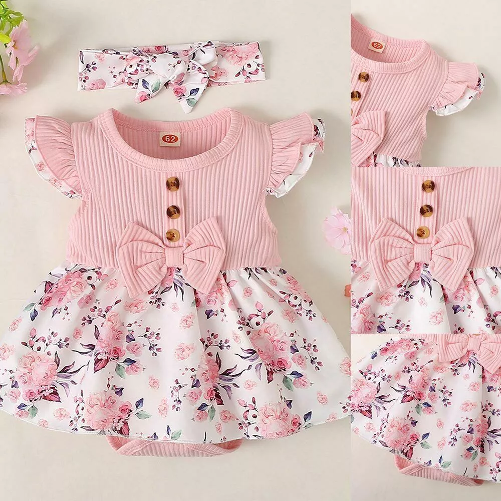 Baby girl floral dress set with ribbed bodice, waist bow, floral skirt, and matching headband, displayed for catalog.