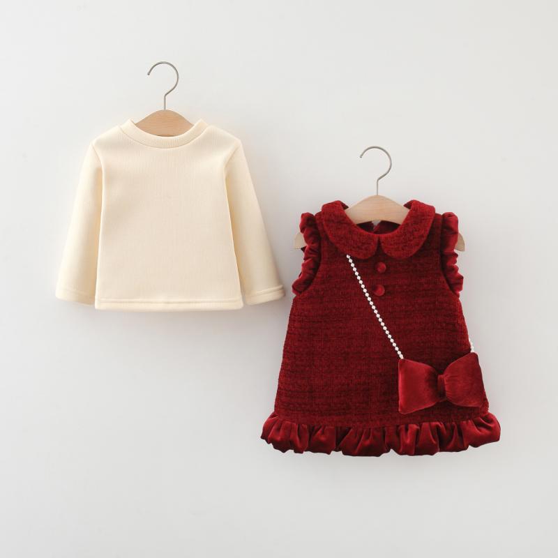 Baby girl red velvet dress set with Peter Pan collar, ruffled trim, decorative buttons, and cream long‑sleeve top, displayed for catalog.