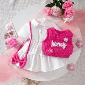 Girls white dress and pink knitted vest set with embroidery, floral appliqués, tiered skirt, and matching accessories, displayed for catalog