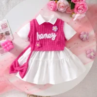 Girls white dress and pink knitted vest set with embroidery, floral appliqués, tiered skirt, and matching accessories, displayed for catalog