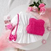 Girls white dress and pink knitted vest set with embroidery, floral appliqués, tiered skirt, and matching accessories, displayed for catalog