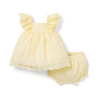 Baby girl bloomers dress set with sleeveless dress, ruffled straps, scalloped hem, and matching bloomers, displayed for catalog.