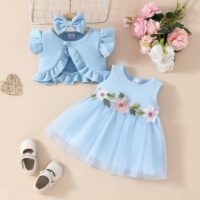 Elegant baby girl outfit set with sleeveless dress, ruffled cardigan, and bow headband, displayed with baby shoes for catalog