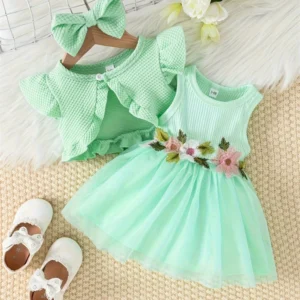 Elegant baby girl outfit set with sleeveless dress, ruffled cardigan, and bow headband, displayed with baby shoes for catalog