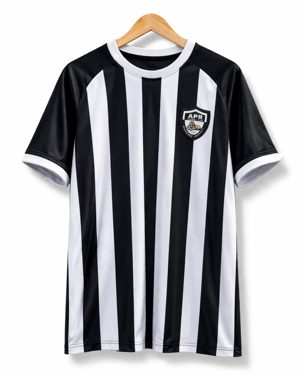 Official APR FC home jersey with black and white vertical stripes and club lion crest on a wooden hanger – Tsapa Rwanda.