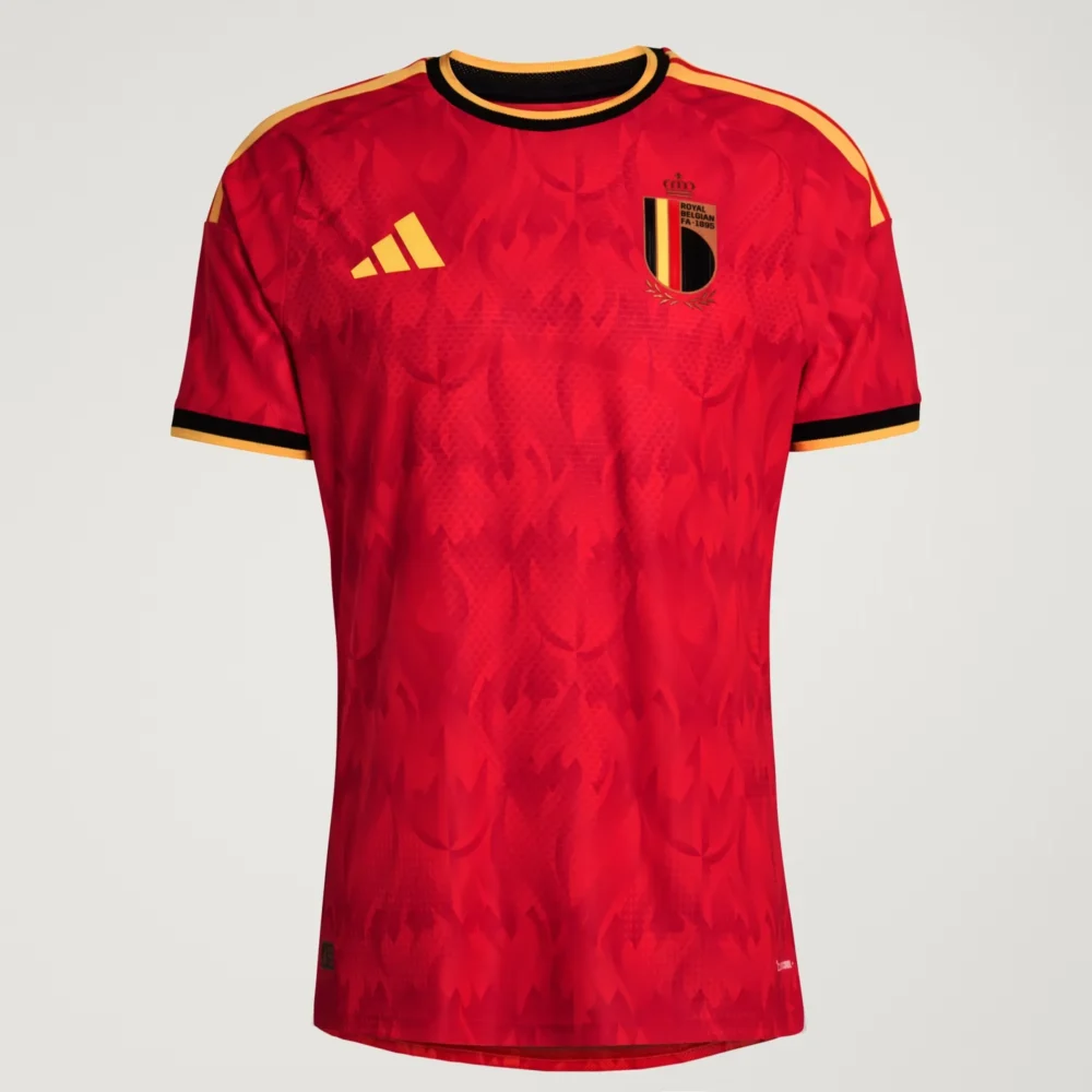 Belgium_26_Home_Authentic_Jersey_Red Front studio flat-lay view of the ared Belgium 2026 home football jersey with an all-over flame pattern and gold logos — Tsapa Rwanda Premium Sportswear.