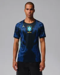 CBF+M+NK+DF+JSY+SS+STAD+AW3 A man modeling the official dark blue Brazil national football team away jersey featuring a bright blue abstract vertical pattern on tsapa with fast delivery in kigali, Rwanda