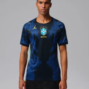 A man modeling the official dark blue Brazil national football team away jersey featuring a bright blue abstract vertical pattern on tsapa with fast delivery in kigali, Rwanda