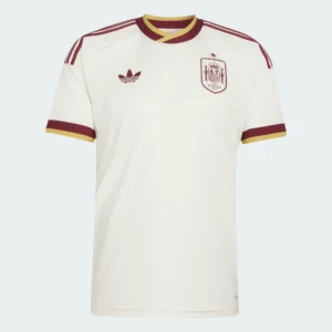 ront flat-lay view of the Adidas Spain 2026 away football jersey in cream with lavender and gold accents — Premium Sportswear Delivery Rwanda.