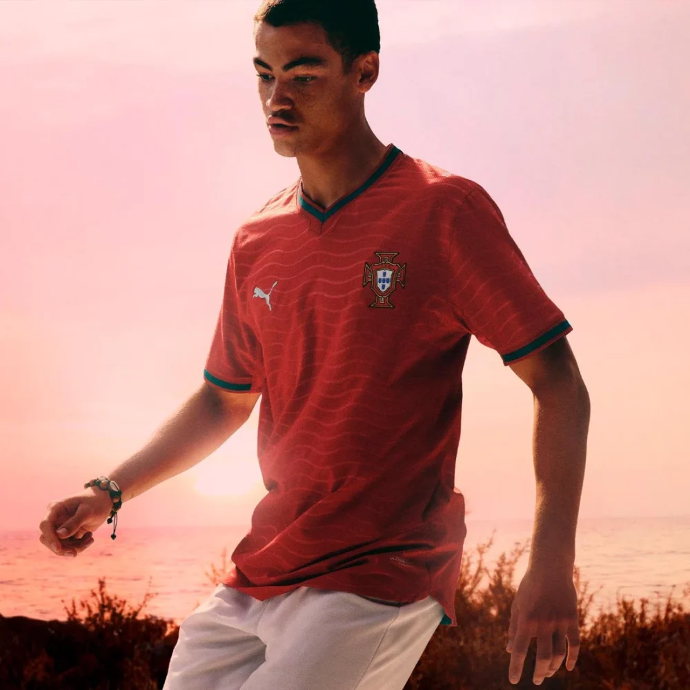 Official 2026 Portugal national football team 2026 home jersey in red with a teal V-neck collar and wavy horizontal patterns