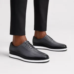 Luxury Berluti black textured leather Derby shoes with a bold white platform sole.