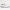 Lateral profile view of a luxury Prada low-top sneaker in white leather with a black treaded outsole — Premium Men's Designer Footwear Rwanda.
