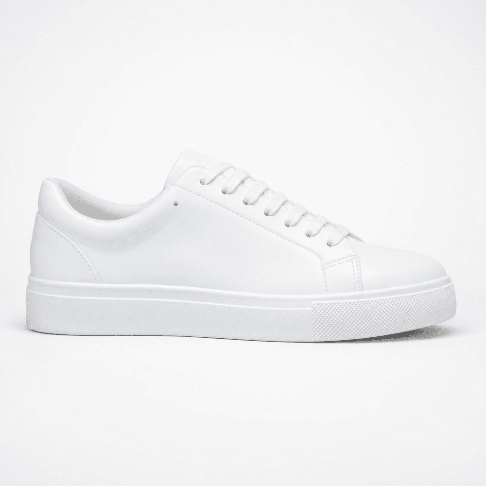Lateral profile view of a white Zara men's minimalist low-top court sneaker in smooth leather with matching white laces and a thick rubber sole — Casual Men's Designer Footwear Rwanda.
