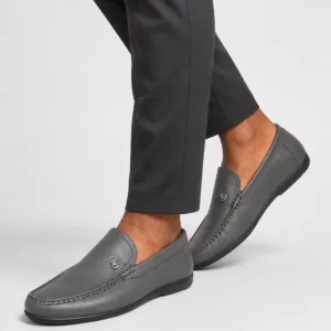 a man in Grey leather apron-toe moccasin loafers for men with crest emblem
