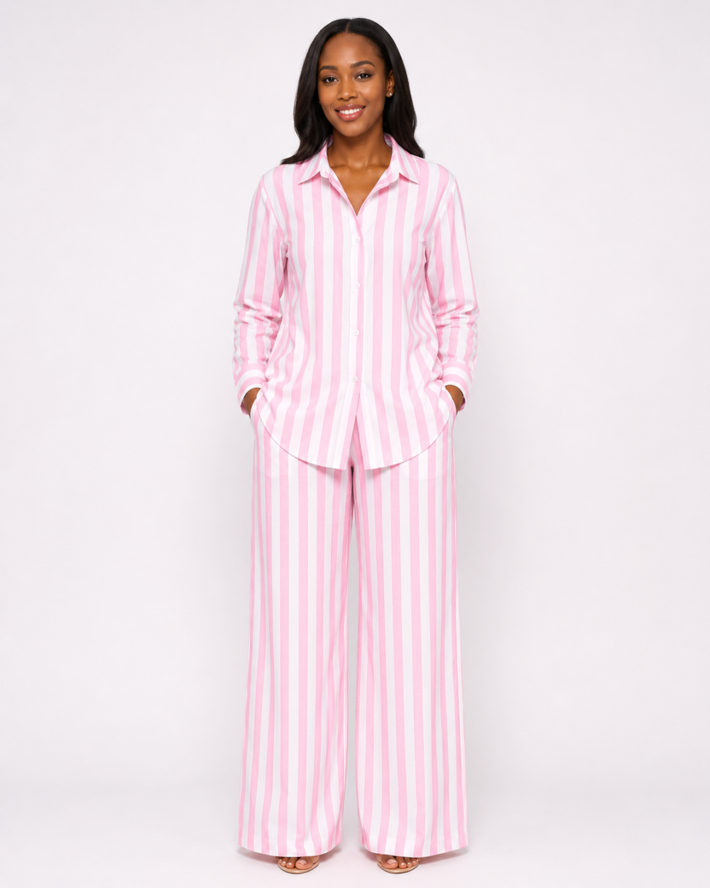 Women’s Pink and White Striped Wide-Leg Co-ord Set Woman wearing a pink and white striped long-sleeve shirt and wide-leg trouser set