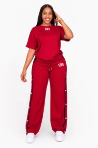 Woman wearing a red T-shirt and wide-leg side-snap track pants set