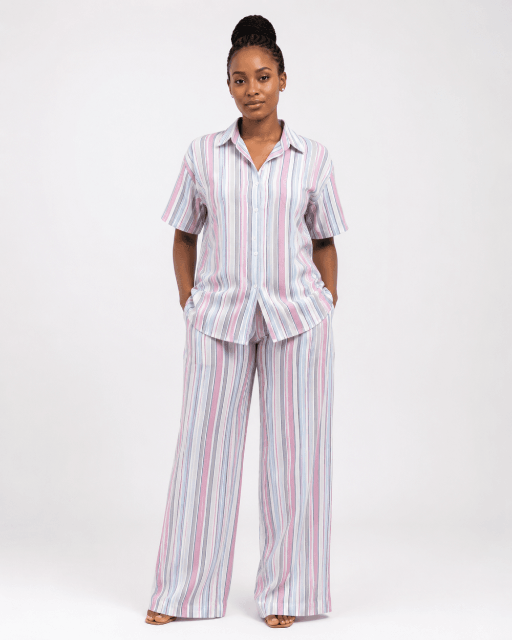 Women’s Pastel Striped Shirt and Wide-Leg Trouser Set Image caption Woman wearing a pastel vertical-striped shirt and wide-leg trouser two-piece set