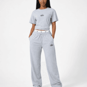 Full-length studio view of model wearing alo heather light grey cropped t-shirt and wide-leg sweatpants two-piece set with logo waistband — Women's Fashion Rwanda.