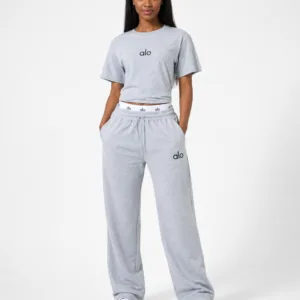 Full-length studio view of model wearing alo heather light grey cropped t-shirt and wide-leg sweatpants two-piece set with logo waistband — Women's Fashion Rwanda.