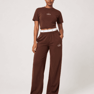 Full-length studio view of model wearing alo chocolate brown cropped t-shirt and wide-leg sweatpants two-piece set — Women's Fashion Rwanda.