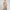 Full-length front view of model wearing beige 3-piece knit ensemble with ribbed top, wide-leg pants, and open cardigan coat — Women's Fashion Rwanda.