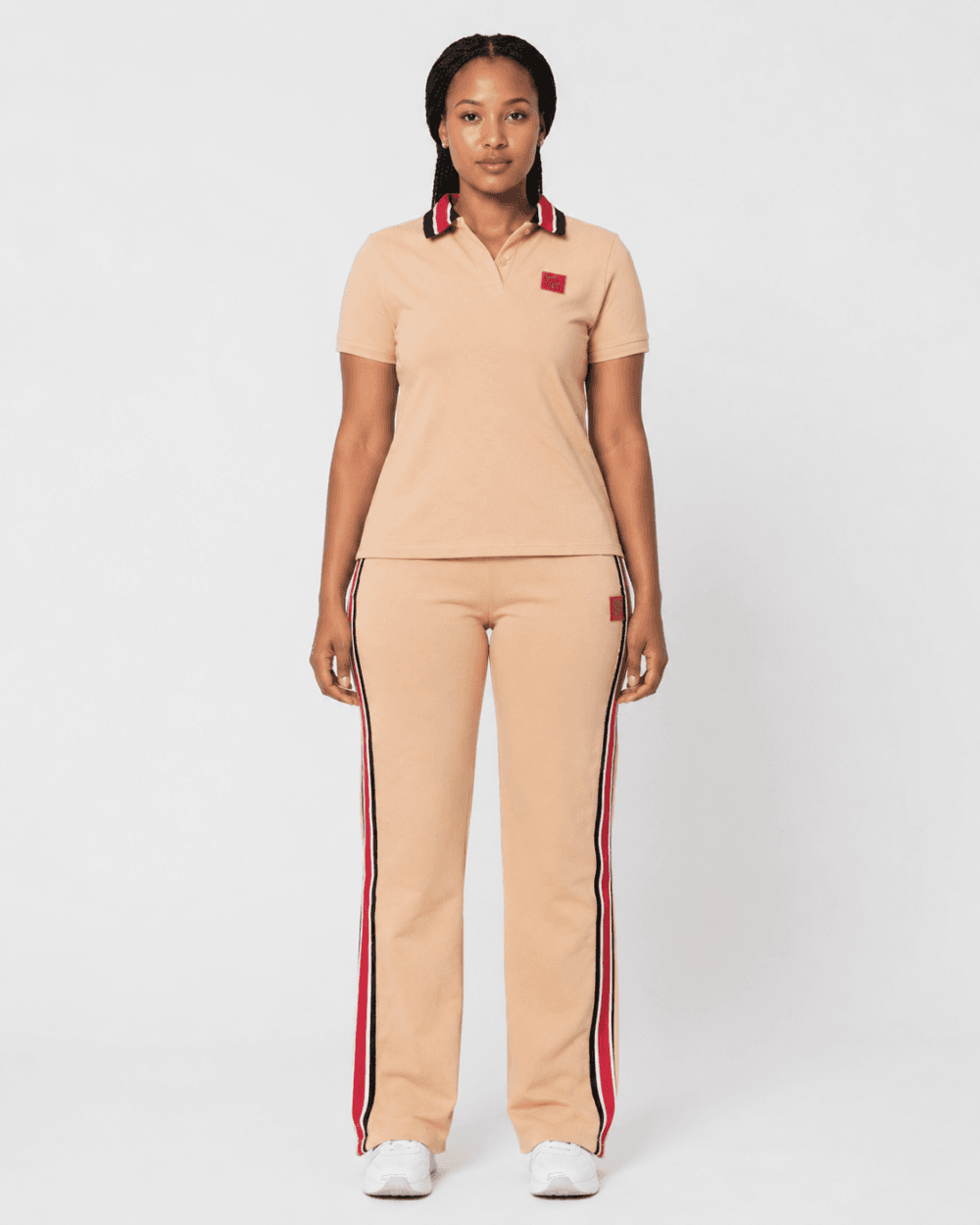 b78127e6-24a2-4f73-aeea-b25d0146a856 Full-length front view of model wearing camel beige short-sleeve polo shirt and side-stripe track pants two-piece set — Women's Fashion Rwanda.