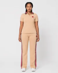 Full-length front view of model wearing camel beige short-sleeve polo shirt and side-stripe track pants two-piece set — Women's Fashion Rwanda.
