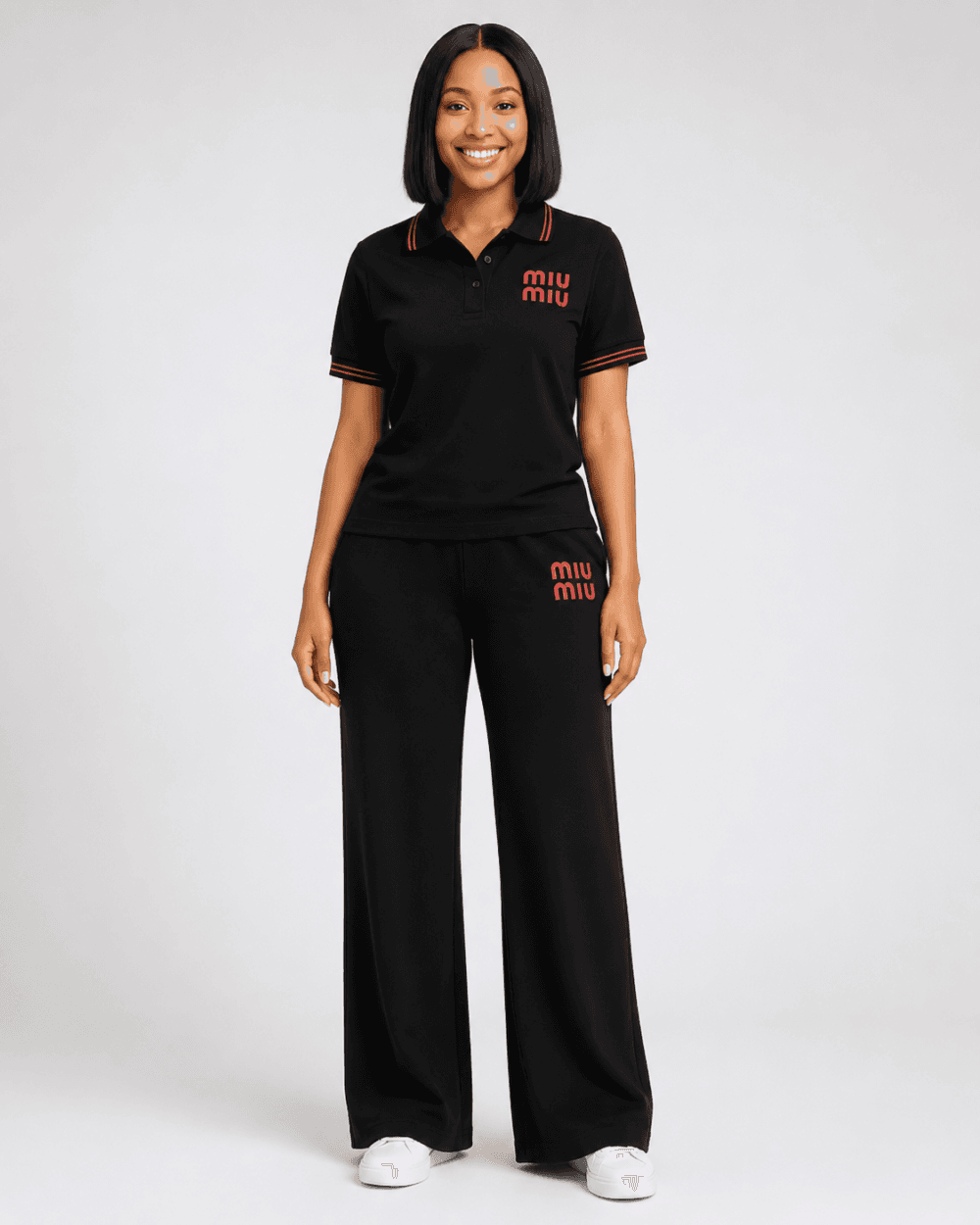 Full-length studio view of model wearing black short-sleeve MIU MIU shirt and wide-leg trousers two-piece set with red contrast trim and logo branding — Women's Fashion Rwanda.