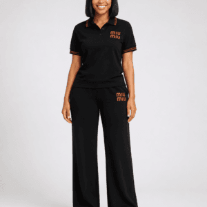 Full-length studio view of model wearing black short-sleeve MIU MIU shirt and wide-leg trousers two-piece set with red contrast trim and logo branding — Women's Fashion Rwanda.