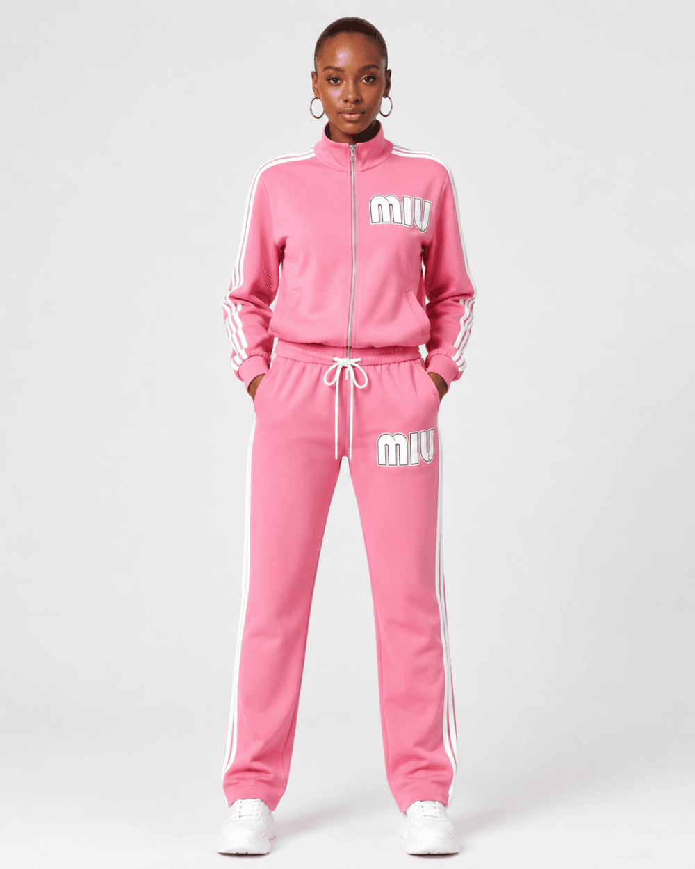 e9a00ffe-680f-416a-a101-cc4a99e7f3e9 Full-length front view of model wearing vibrant pink full-zip track jacket and matching track pants two-piece set with white stripes and MIU logo — Women's Fashion Rwanda.