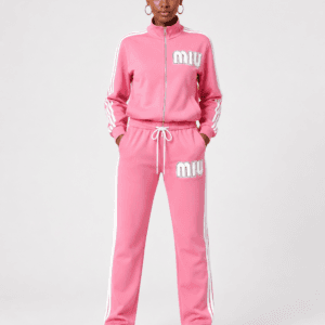 Full-length front view of model wearing vibrant pink full-zip track jacket and matching track pants two-piece set with white stripes and MIU logo — Women's Fashion Rwanda.
