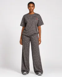 Full-length front view of model wearing charcoal grey acid wash oversized t-shirt and wide-leg sweatpants two-piece set with red logo — Women's Fashion Rwanda.