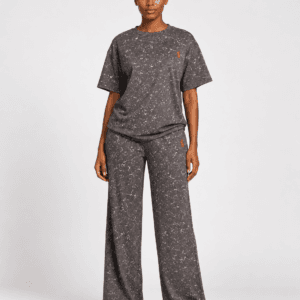 Full-length front view of model wearing charcoal grey acid wash oversized t-shirt and wide-leg sweatpants two-piece set with red logo — Women's Fashion Rwanda.