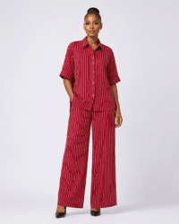 Full-length studio view of model wearing burgundy red pinstripe short-sleeve shirt and wide-leg trousers set — Women's Fashion Rwanda.